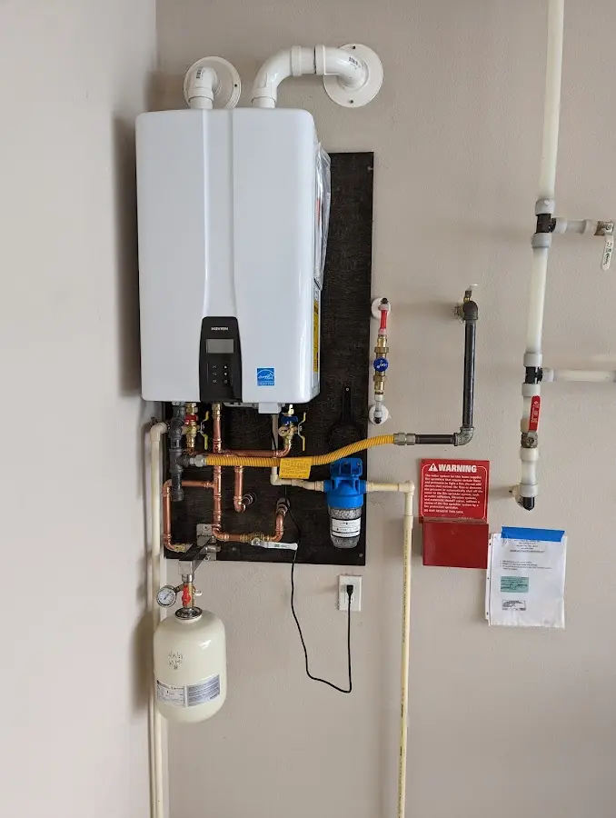 Professional plumber installing copper piping in a Maltby home